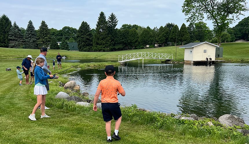 Family's fishing in a pond.