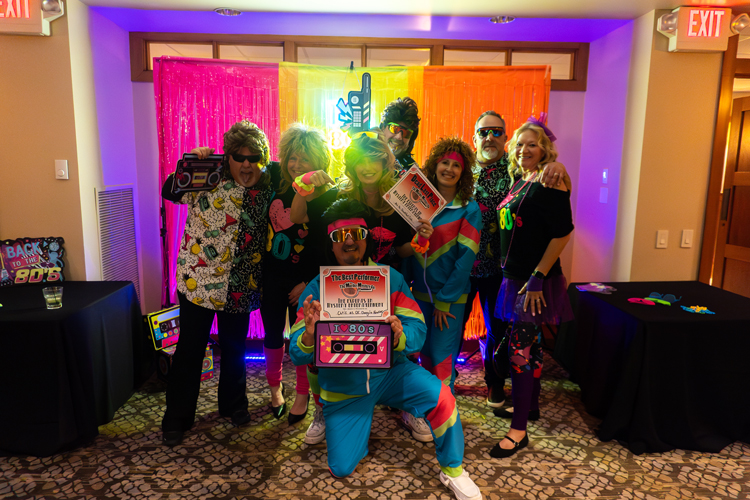 People dressed in outfits inspired by the 1980s.